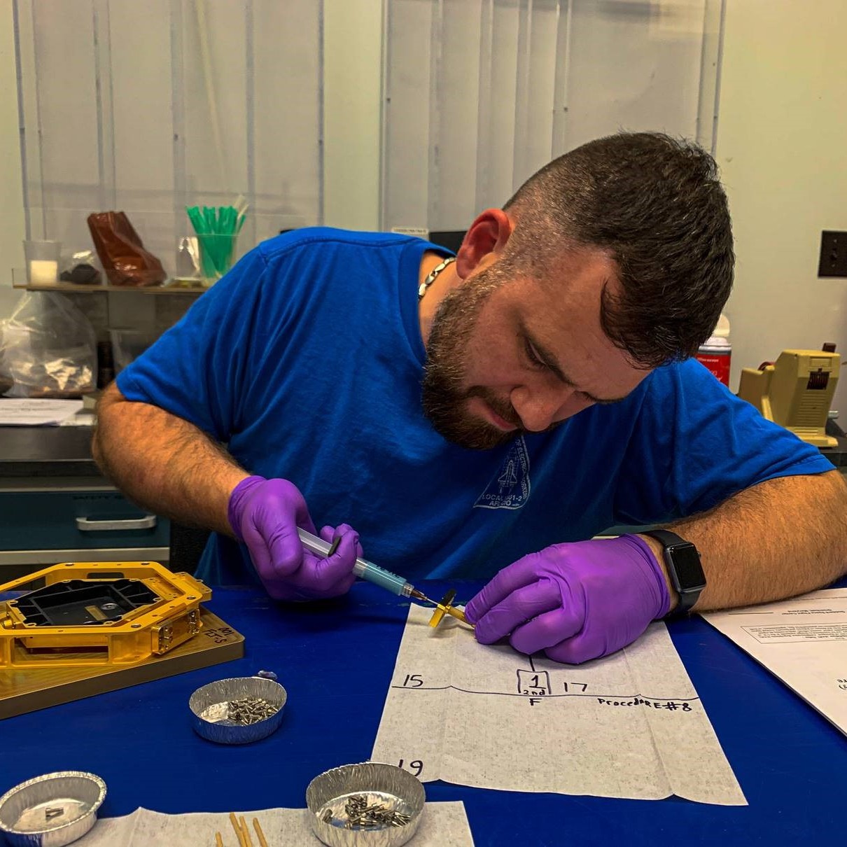 Alekey Luzhin (GSFC) bonding the final end fitting on the LEISA Detector Thermal Isolators for the flight unit.